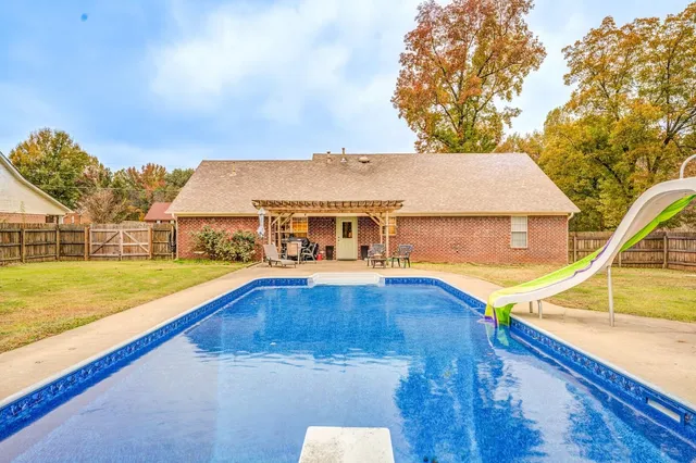 a view of a swimming pool with an outdoor seating and yard