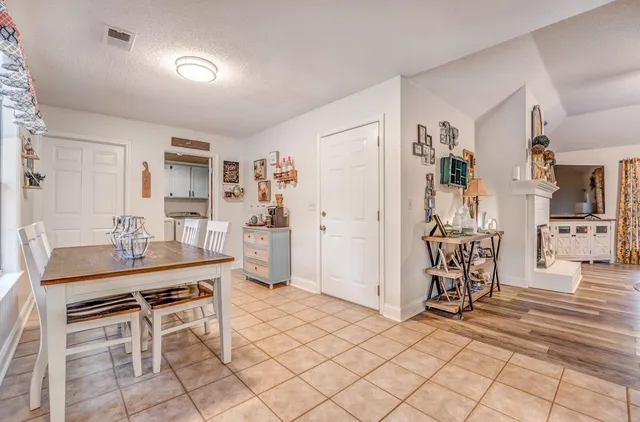 a room with furniture a rug and white walls