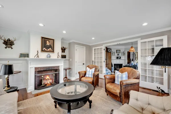 a living room with furniture a fireplace and a flat screen tv