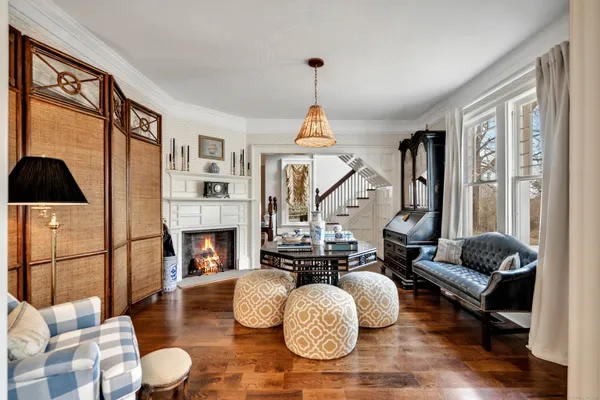 a living room with furniture a fireplace and a large window