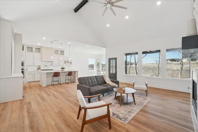 an empty room with a window and wooden floor