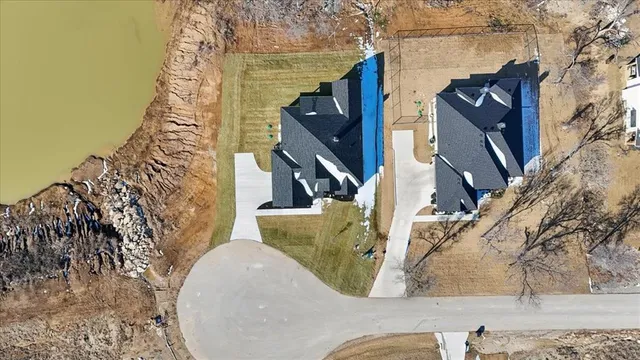 an aerial view of a residential houses with outdoor space