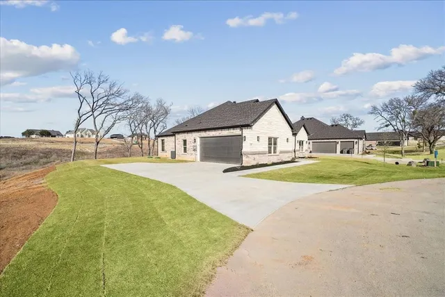 a view of house with yard and ocean view