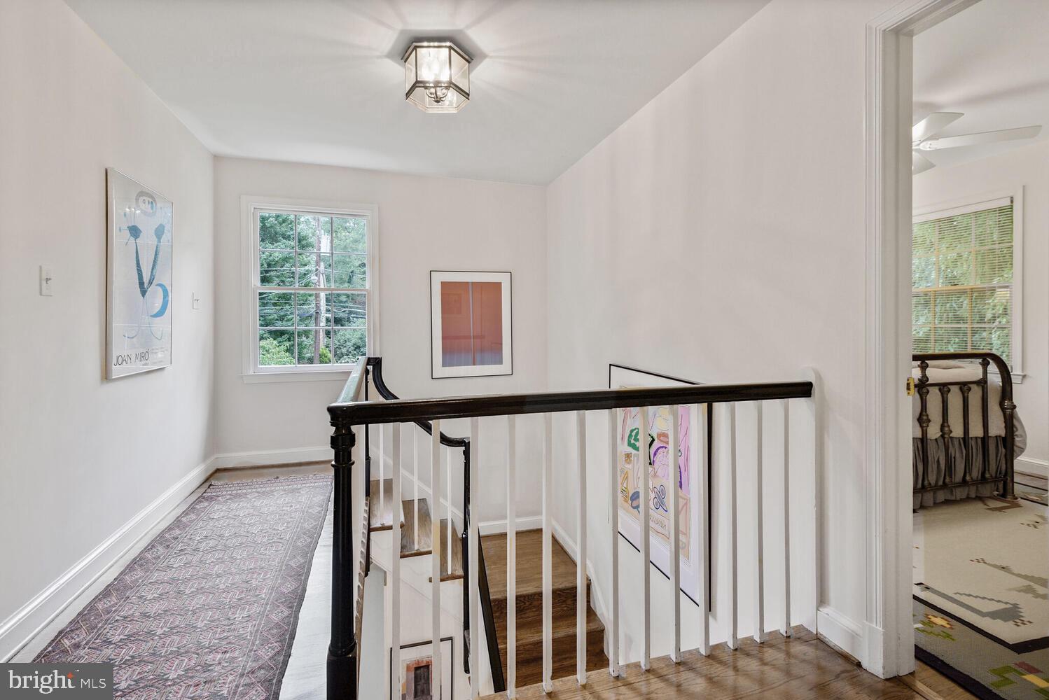 7721 Maryknoll Avenue Bethesda, MD 20817 - Photo 18 of 33 a view of a hallway with wooden floor and windows