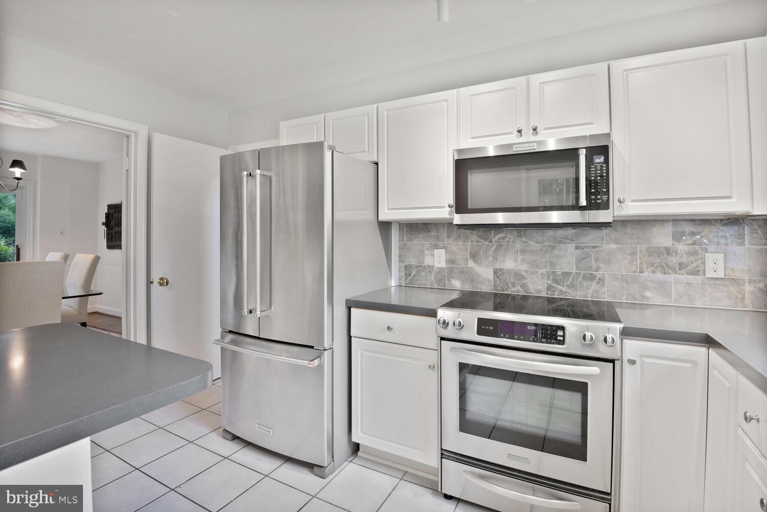 7721 Maryknoll Avenue Bethesda, MD 20817 - Photo 10 of 33 a kitchen with cabinets stainless steel appliances and a counter space