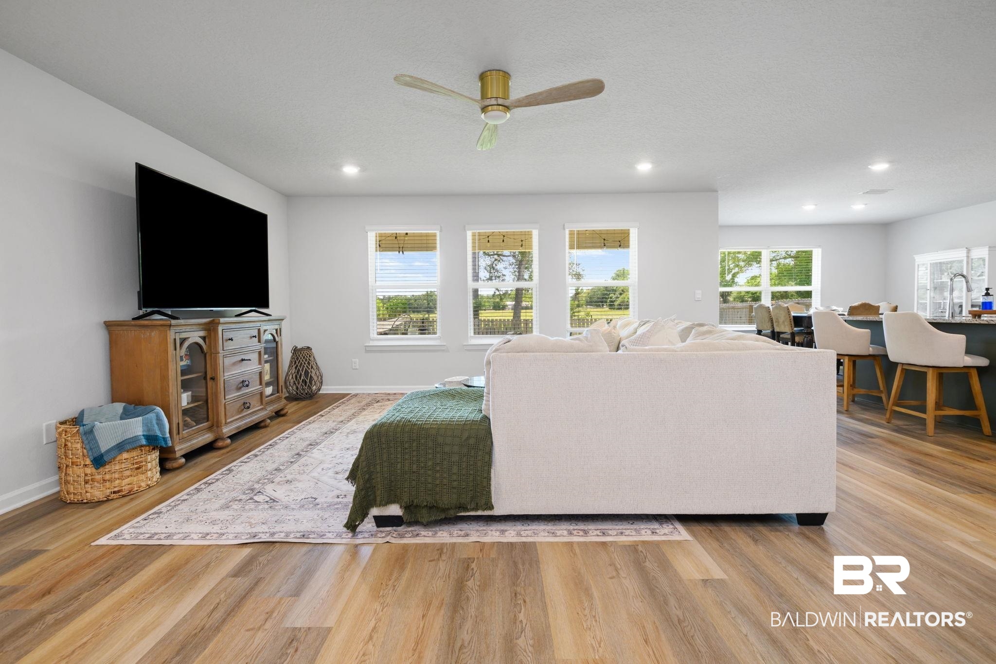 8021 Valor Rdg Way North Mobile, AL 36619 - Photo 21 of 34 Spacious living area featuring wood-finish flooring, recessed lighting, and a ceiling fan
