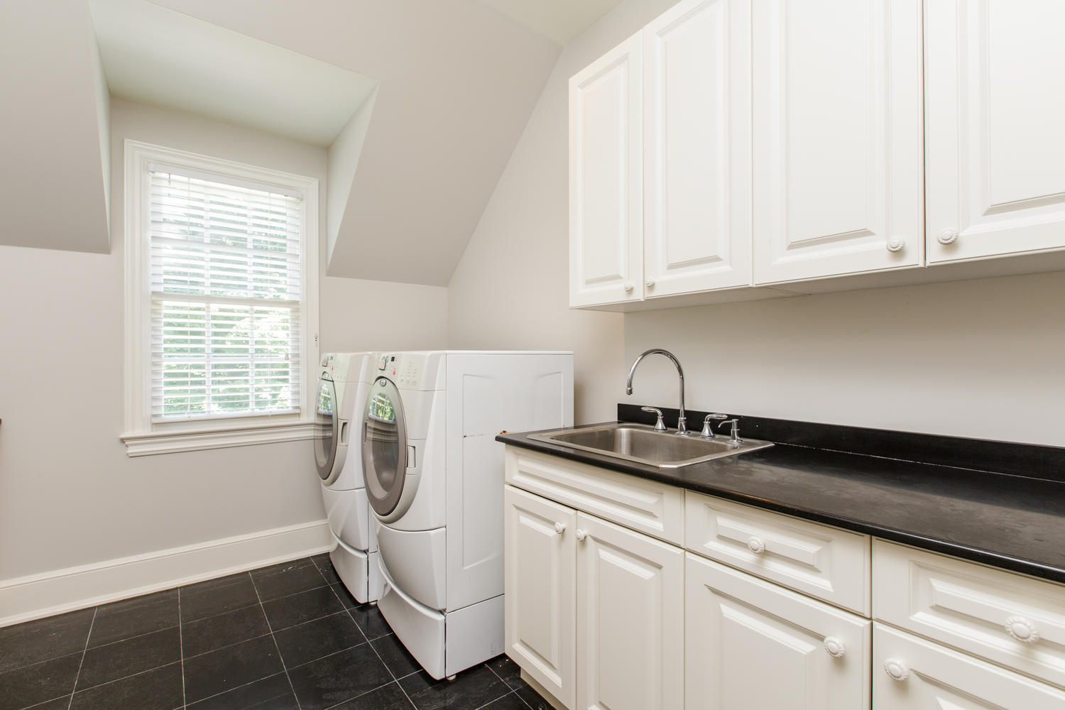 881 Valley Road New Canaan, CT 06840 - Photo 20 of 37 a view of a kitchen with white cabinets