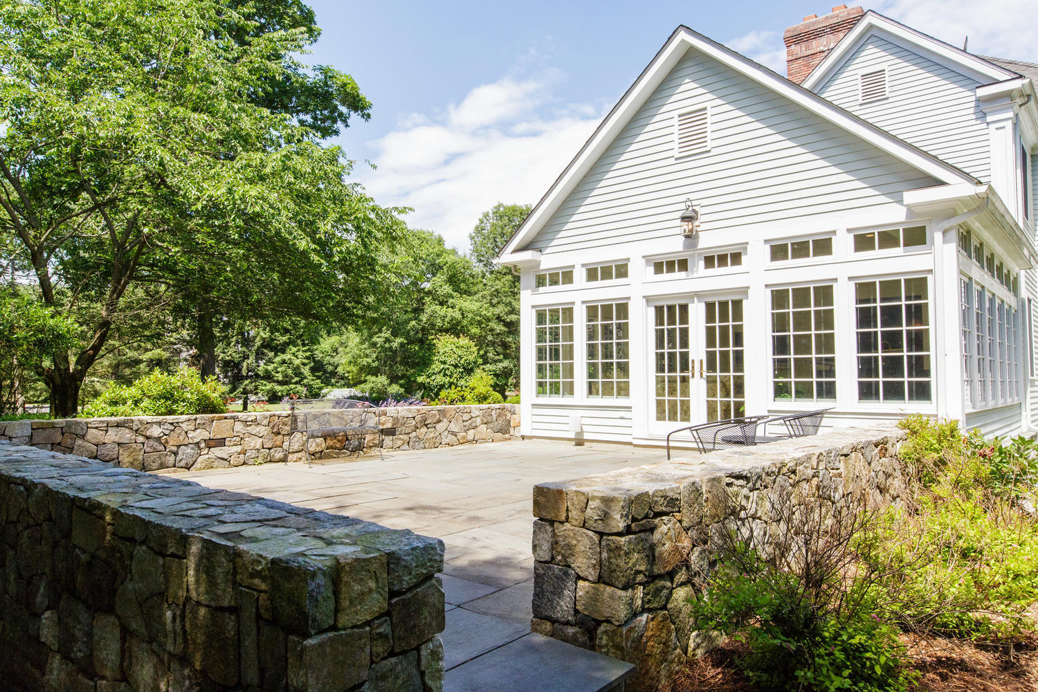881 Valley Road New Canaan, CT 06840 - Photo 29 of 37 a front view of a house with a garden