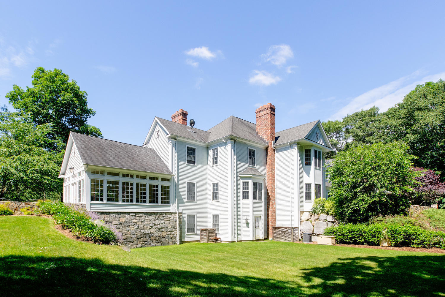 881 Valley Road New Canaan, CT 06840 - Photo 30 of 37 a front view of a house with a yard