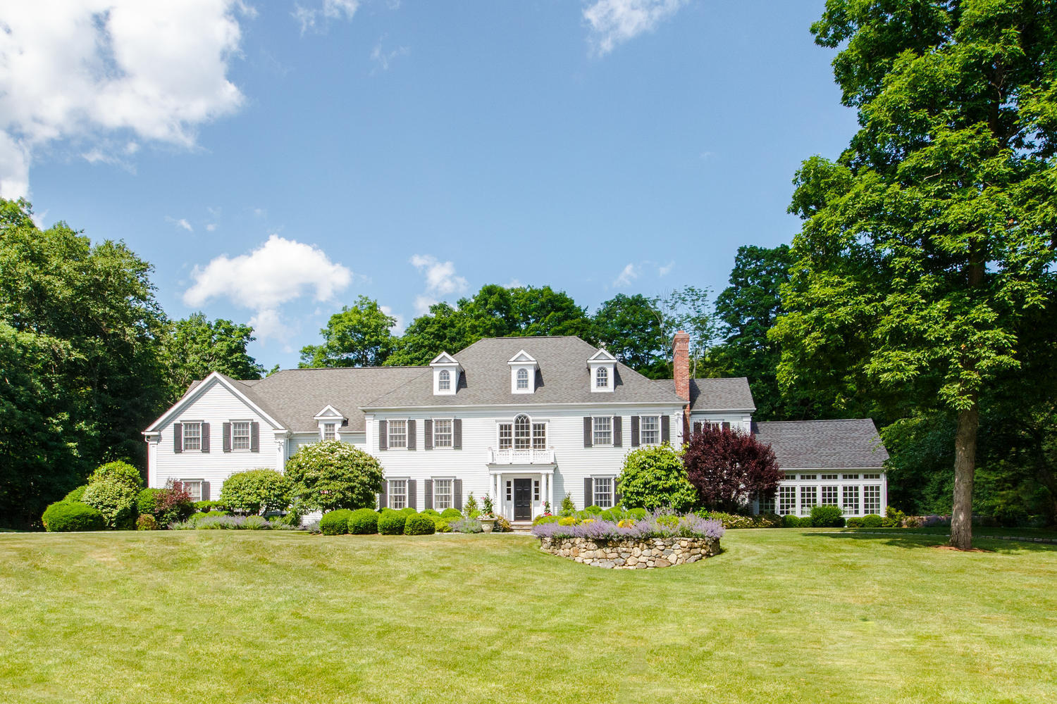 881 Valley Road New Canaan, CT 06840 - Photo 33 of 37 a front view of a house with garden