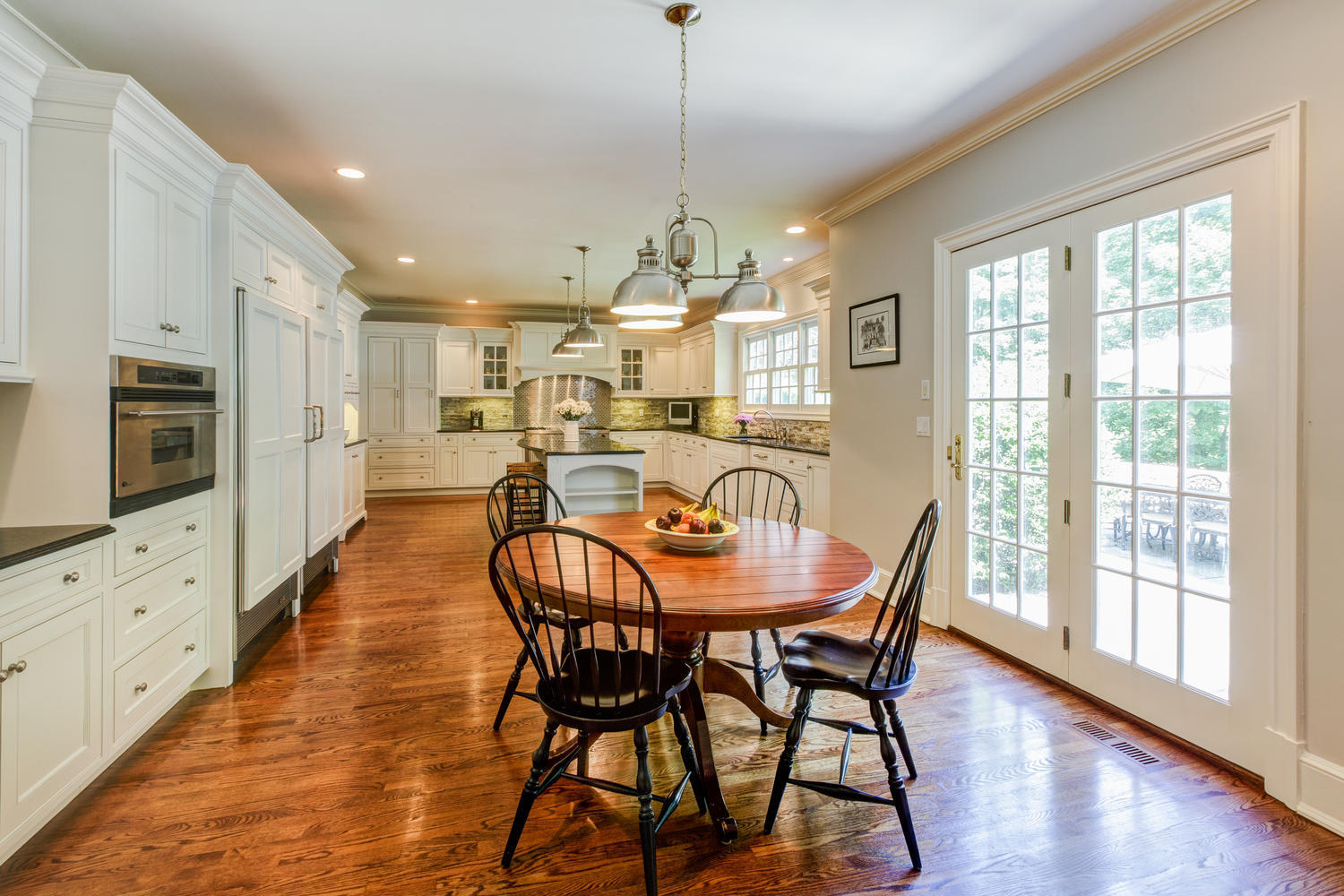 881 Valley Road New Canaan, CT 06840 - Photo 8 of 37 a dining room with furniture a chandelier and wooden floor