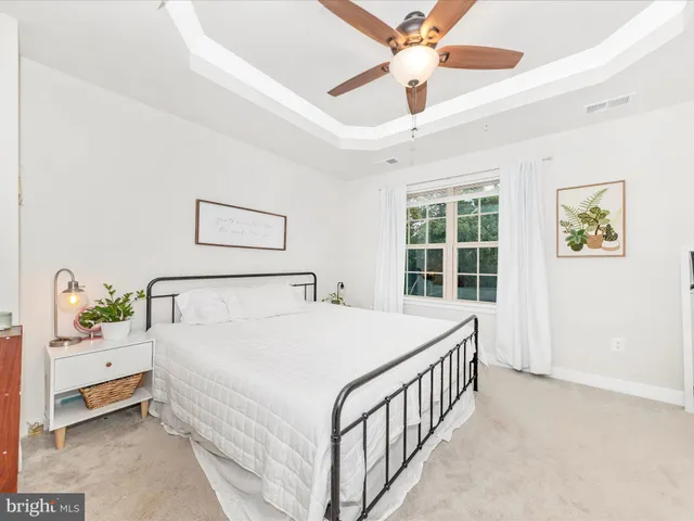 a bed room with a bed and a chandelier