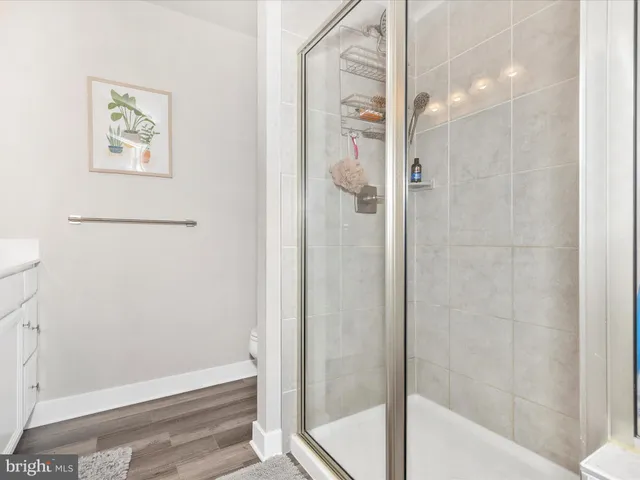 a bedroom with a bed dresser and a window