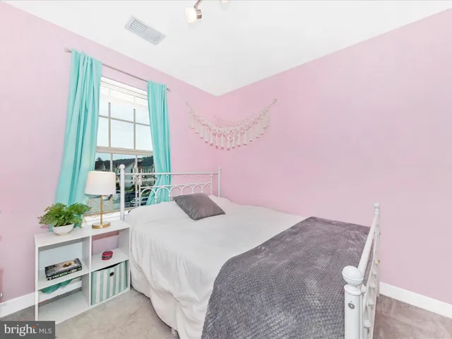 a bathroom with a sink a toilet and shower curtain