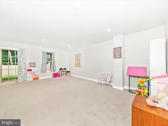 a view of an empty room with toys and a flat screen tv