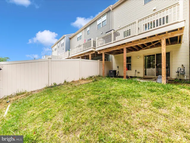a view of balcony with chairs and wooden fence