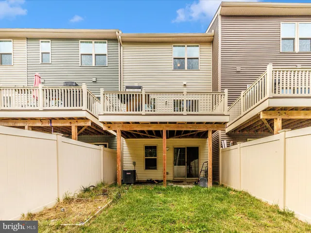 a view of a balcony with wooden floor and fence