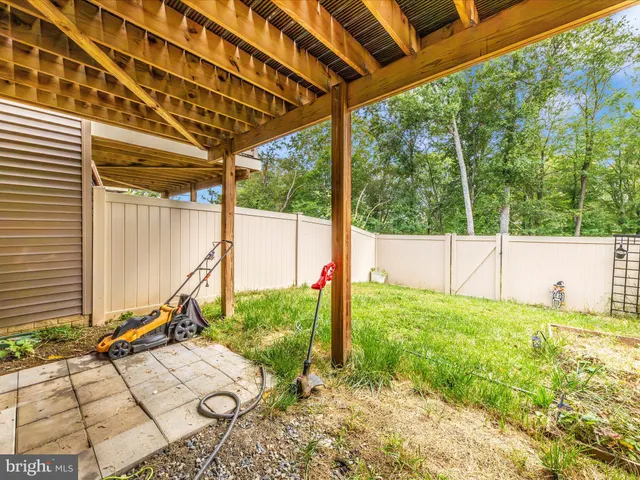 a view of a garden with wooden fence