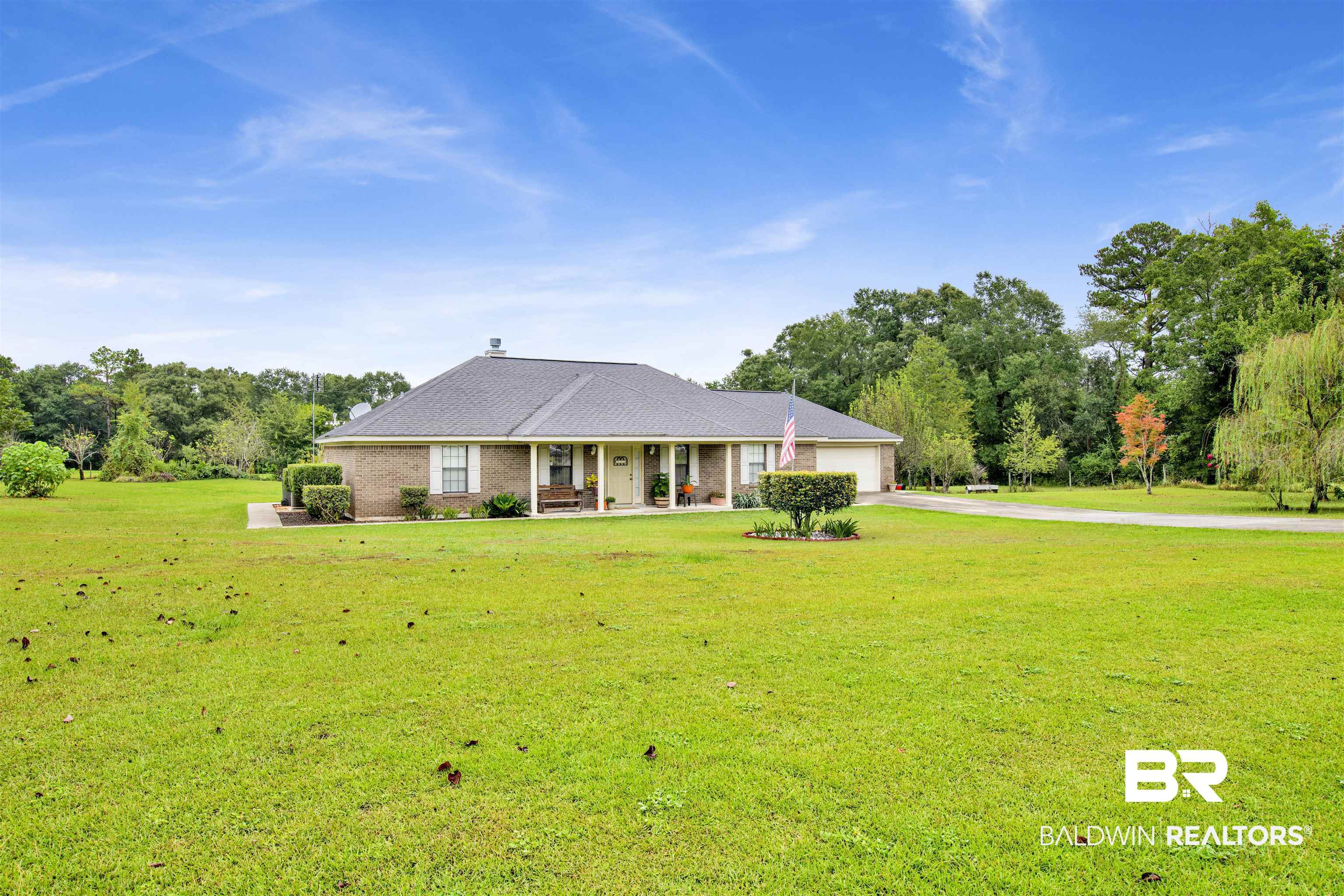 54563 Splinter Hill Road Perdido, AL 36562 - Photo 2 of 29 Ranch-style house with a garage, covered porch, and a front lawn