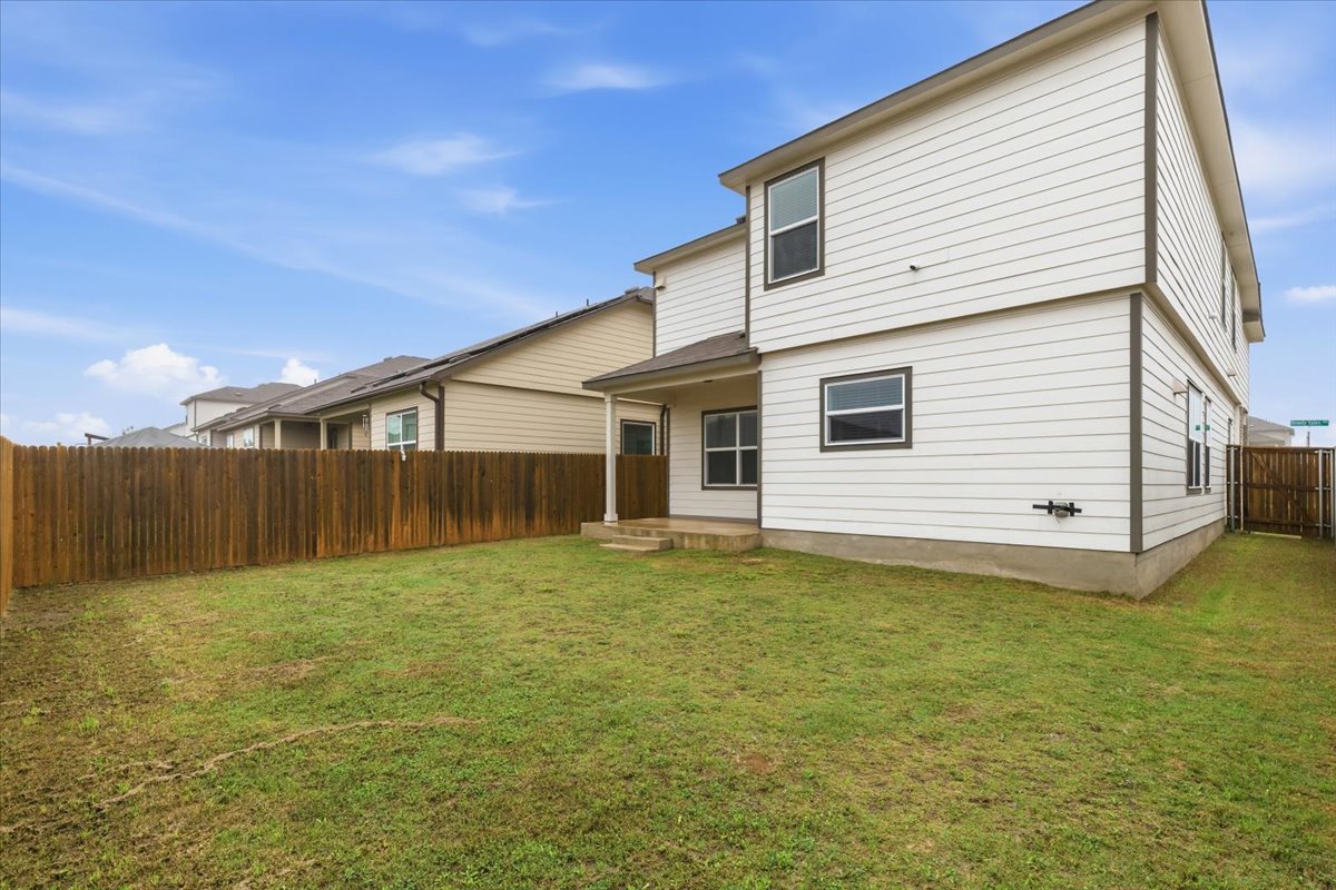 101 Rowdy Yates Way Jarrell, TX 76537 - Photo 30 of 32 Expansive grassy backyard featuring a full-height wood privacy fence