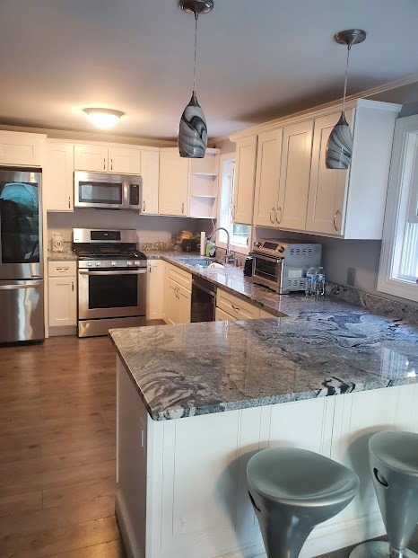 19 Calvin Road Easton, MA 02356 - Photo 5 of 14 a kitchen with stainless steel appliances granite countertop a sink a stove top oven a counter space and cabinets