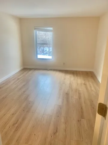 a view of an empty room and a window