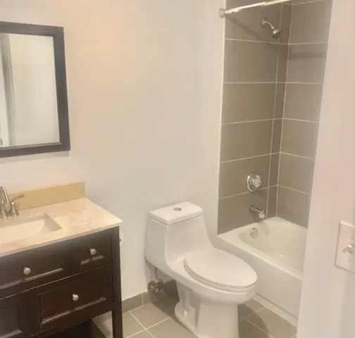 a bathroom with a sink a toilet and mirror