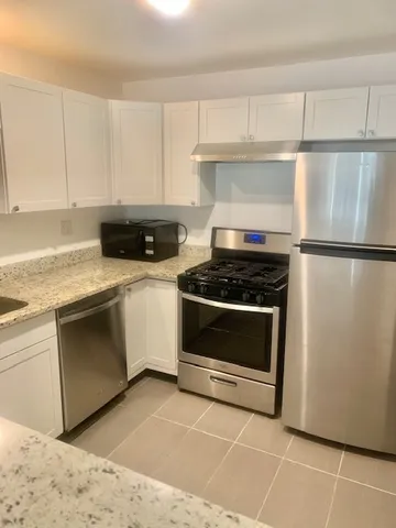 a kitchen with cabinets and appliances