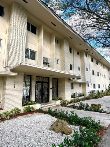 a view of a building with a yard