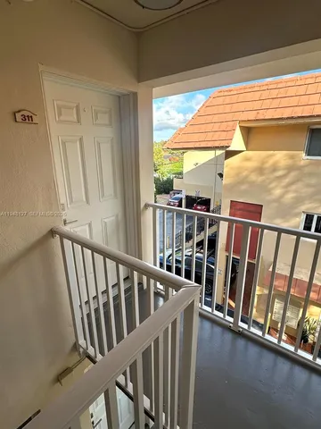 a view of a porch with wooden floor