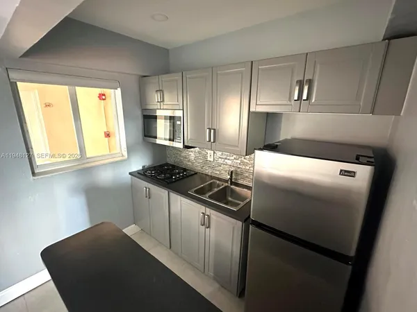 a kitchen with a stove and a refrigerator