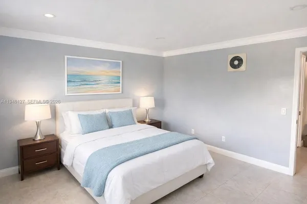 a bedroom with a bed and a lamp