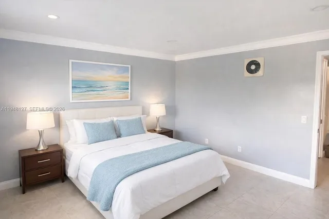 a bedroom with a bed and a lamp