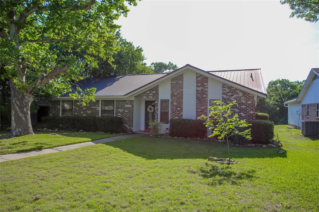1720 Crystal Way Plano, TX 75074 - Photo 2 of 32 a front view of a house with a yard and garage