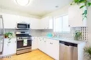 a kitchen with stainless steel appliances a stove a sink and a microwave