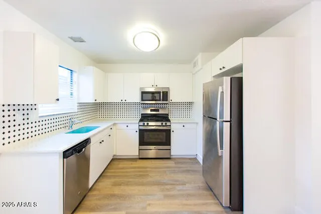 a kitchen with a refrigerator and a sink