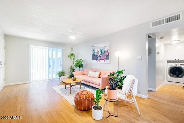 a living room with furniture and wooden floor
