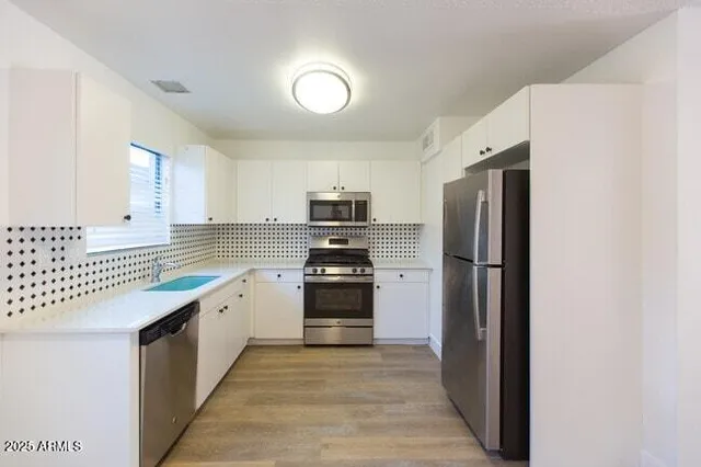 a kitchen with a refrigerator and a sink