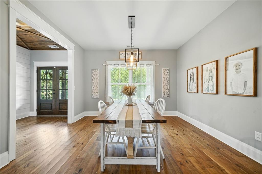 14430 Fincher Road Ball Ground, GA 30107 - Photo 16 of 51 a view of a dining room with furniture window and wooden floor