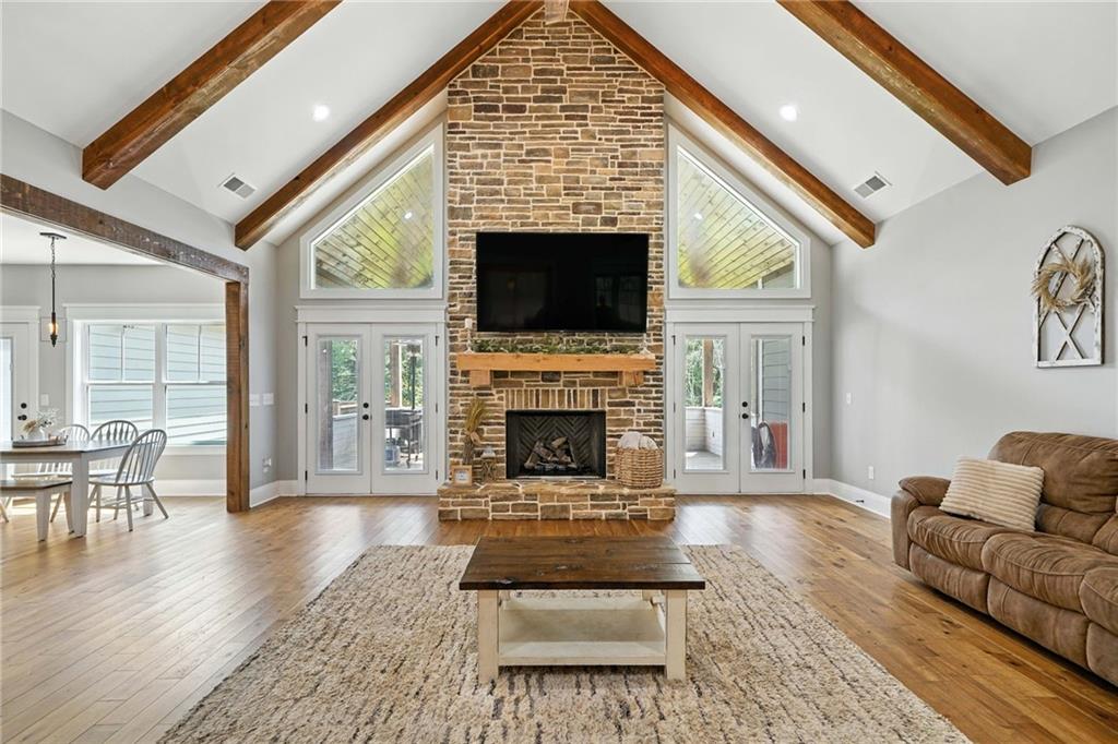 14430 Fincher Road Ball Ground, GA 30107 - Photo 18 of 51 a living room with furniture a flat screen tv and a fireplace