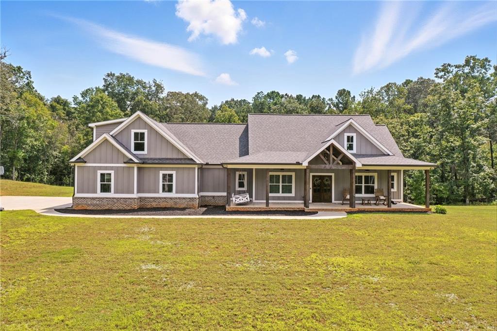 14430 Fincher Road Ball Ground, GA 30107 - Photo 2 of 51 a front view of a house with a big yard and potted plants