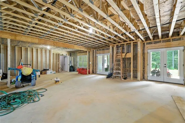 a bathroom with a toilet sink vanity and mirror