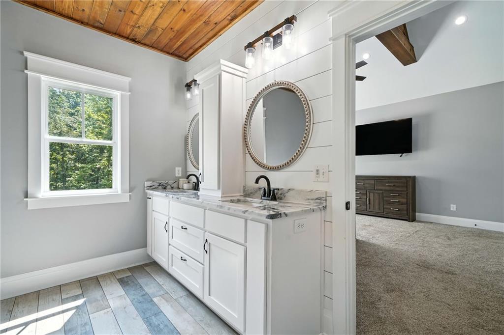 14430 Fincher Road Ball Ground, GA 30107 - Photo 34 of 51 a bathroom with a double vanity sink and a mirror