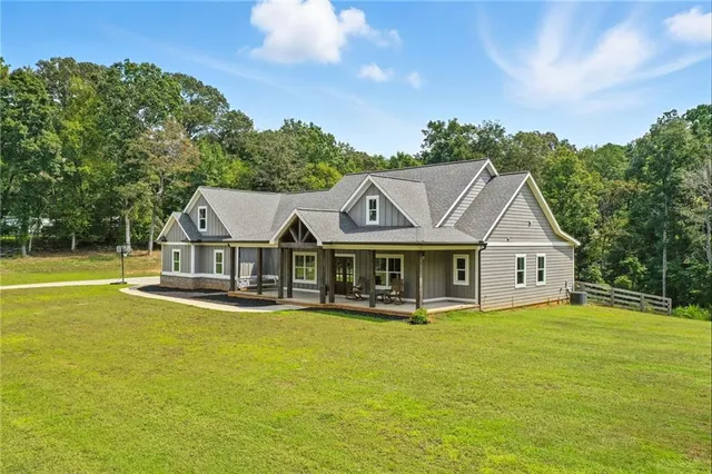 an aerial view of a house with swimming pool garden view and trees