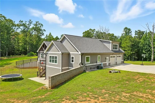 a view of a house with a big yard and potted plants