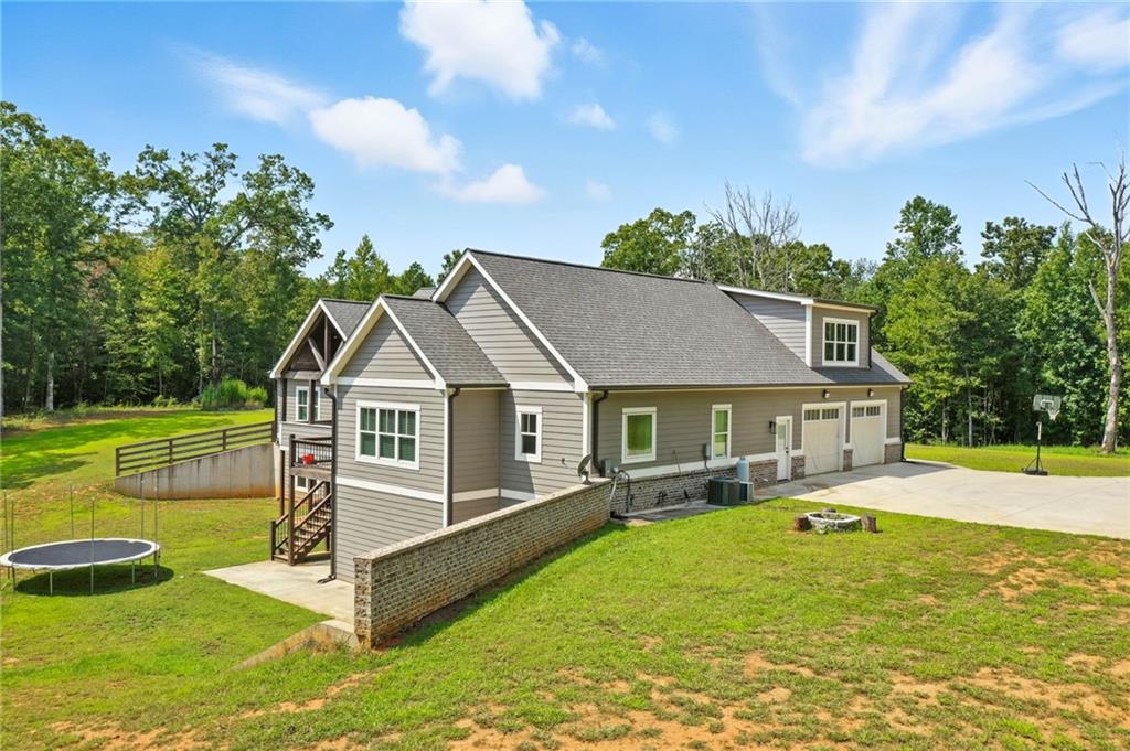 14430 Fincher Road Ball Ground, GA 30107 - Photo 8 of 51 a view of a house with a big yard and potted plants