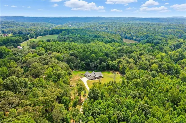 a view of a lake in middle of green field