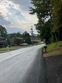 a view of a street with a yard