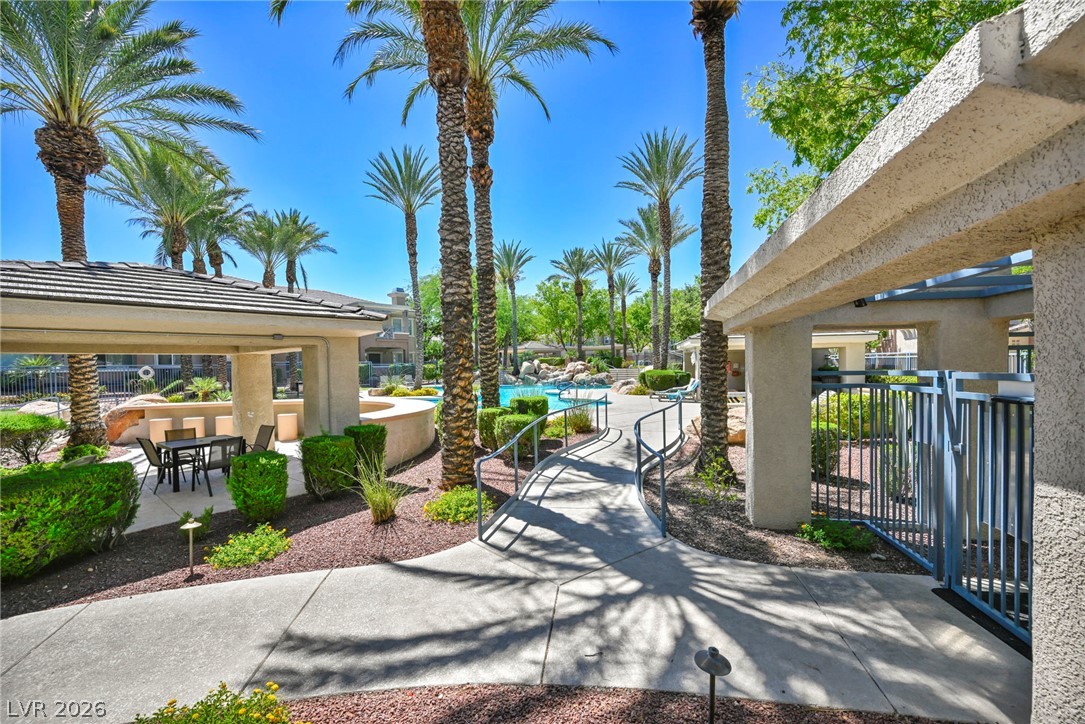 10730 Amber Ridge Drive, Unit 101 Las Vegas, NV 89144 - Photo 30 of 32 A tranquil oasis featuring a resort-style pool and a covered patio for ultimate relaxation.