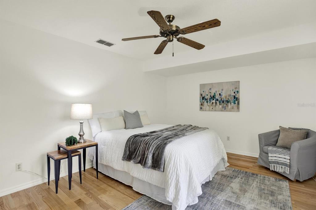 4684 West Huron Road St. Petersburg, FL 33708 - Photo 14 of 31 a spacious bedroom with a bed and a chandelier